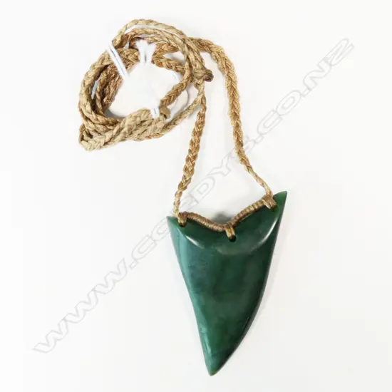 Te Kaha carved pounamu (gem inanga) rei niho (eye tooth) pendant,